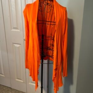 Bright orange cardigan.